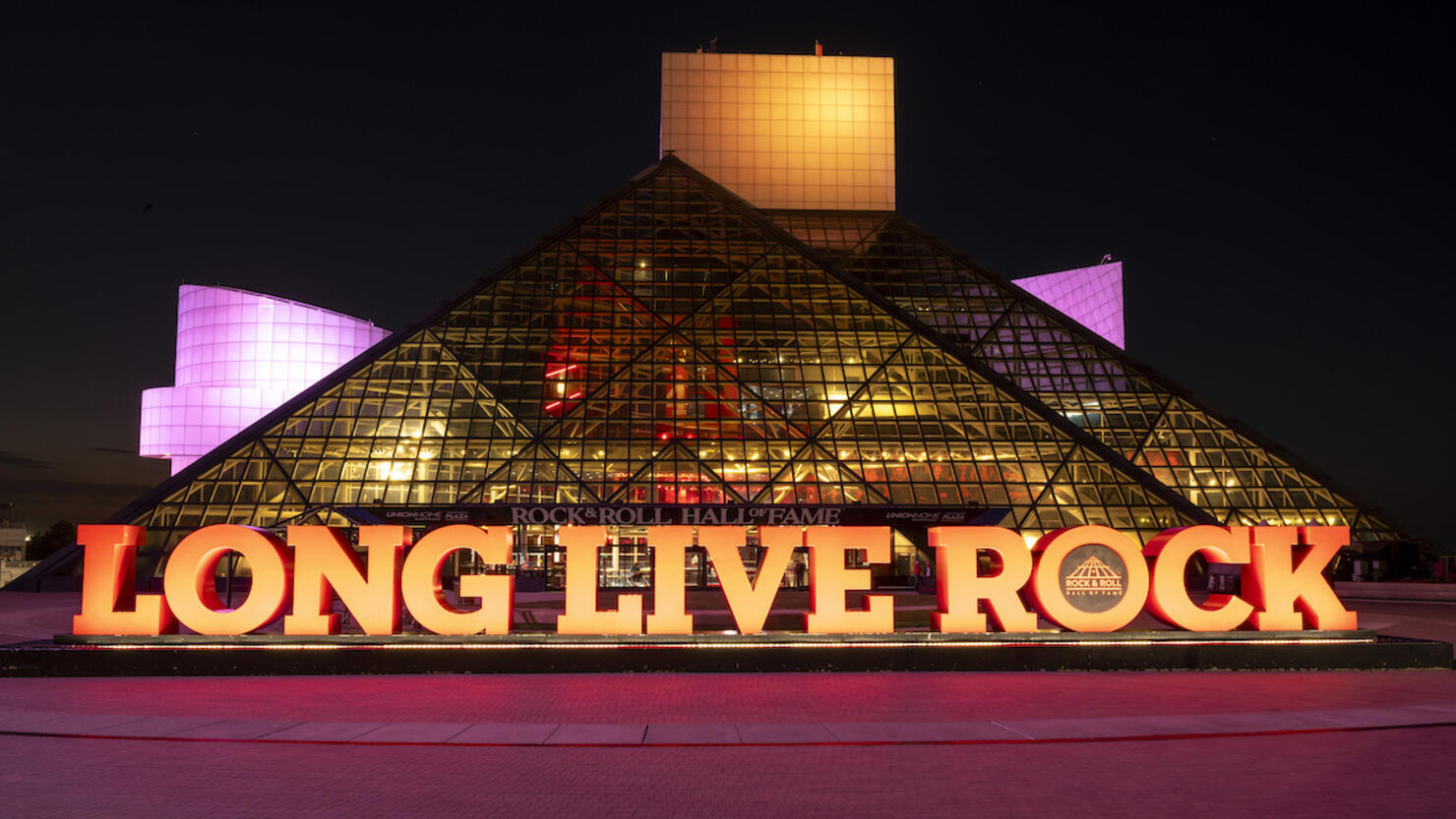 Rock & Roll Hall Of Fame Lit In CARE Colors For International Day Of The Girl