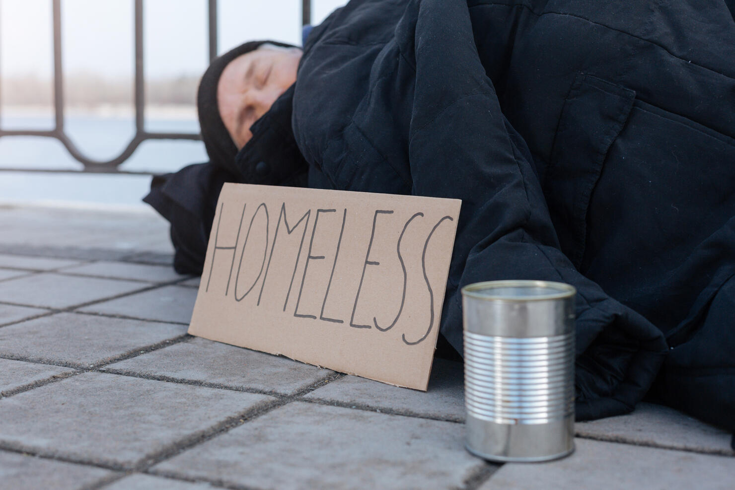 Side view photo of homeless person while resting