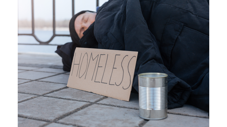 Side view photo of homeless person while resting