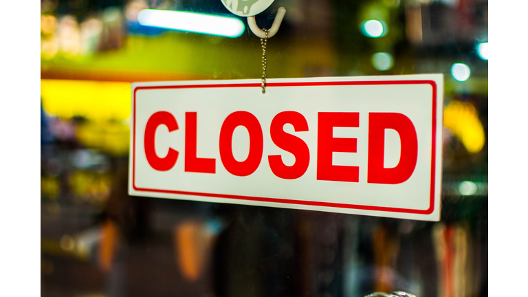 A glass door with "closed" store sign