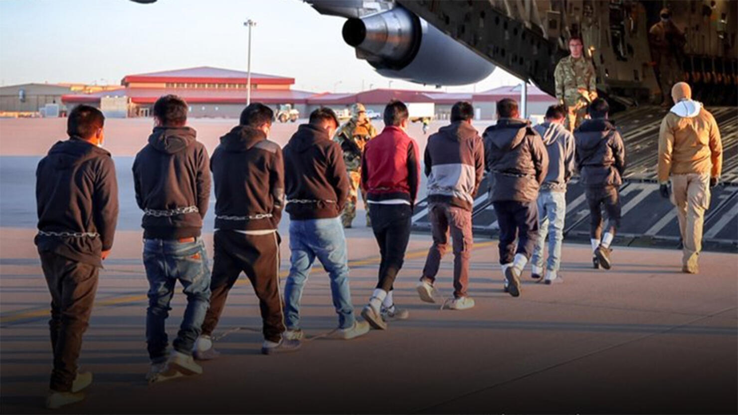 Illegal Immigrants board a deportation flight