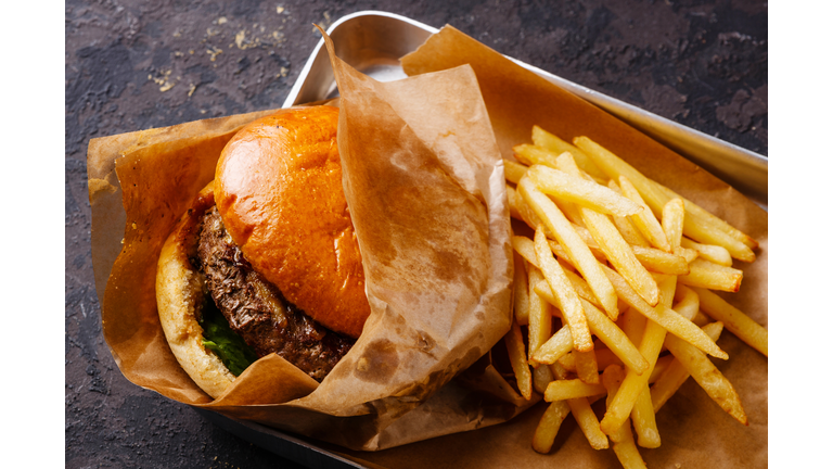 Burger and French fries in aluminum tray