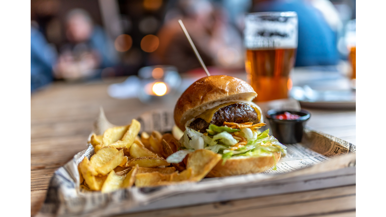 A Burger with French Fries on the Side and a craft beer