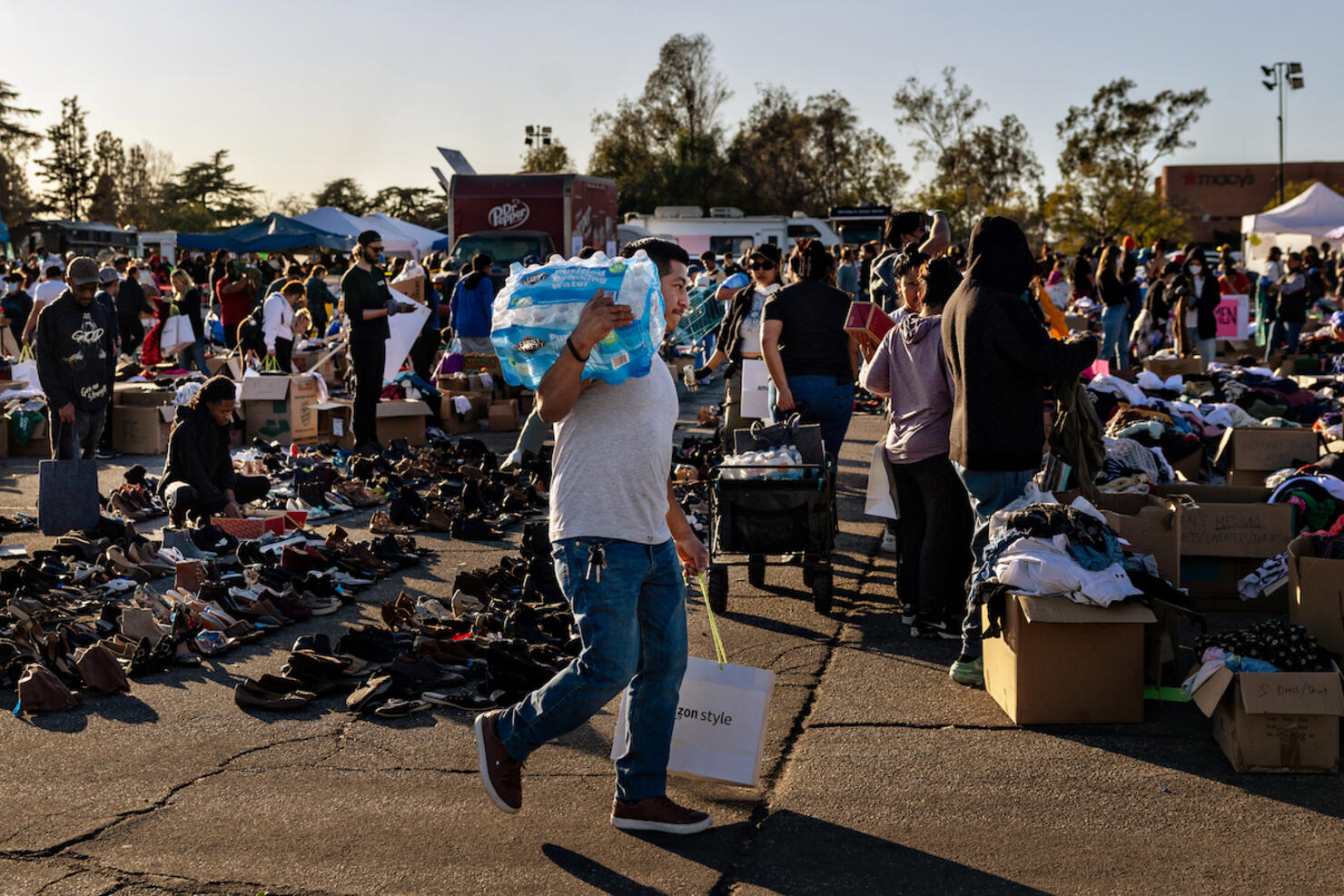 Community members stop by a donation center that has taken over the parking lot at the Santa Anita Racetrack after the Eton fire in Altadena