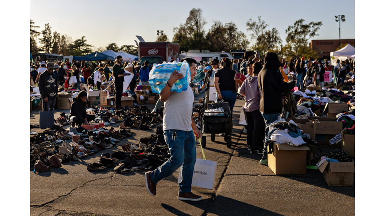 Community members stop by a donation center that has taken over the parking lot at the Santa Anita Racetrack after the Eton fire in Altadena