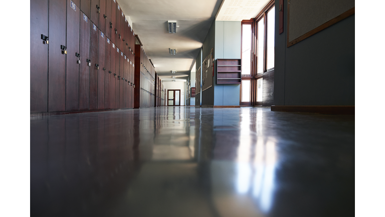 Surface level view of empty corridor with lockers