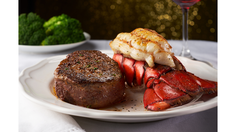 Steak and Lobster on a White Plate and Table Cloth