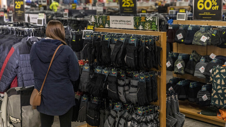 Shopper looks through winter garments during Black Friday at