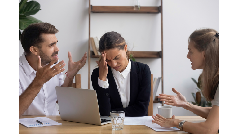 Stressed annoyed office employee having headache migraine at business meeting