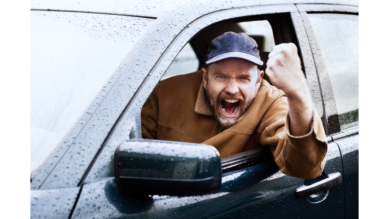 Road rage rules with this infuriated driver shaking his fist