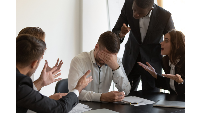 Frustrated employee feels stressed suffers from hostile coworkers