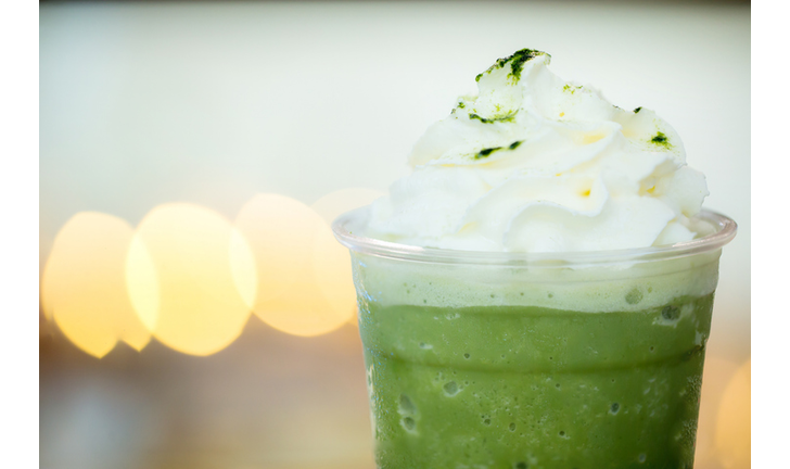 Close up whip cream on green tea latte with light bokeh background, soft and blur style for background, wallpaper and copy space.