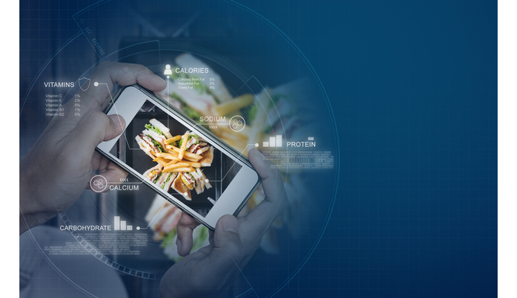 Food Nutrition Scanning Technology, and Healthy eating Lifestyles. hand using mobile smart phone checking nutrition facts