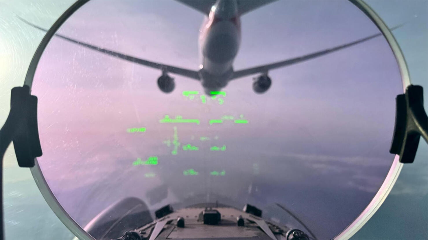 Fighter jet following an airplane