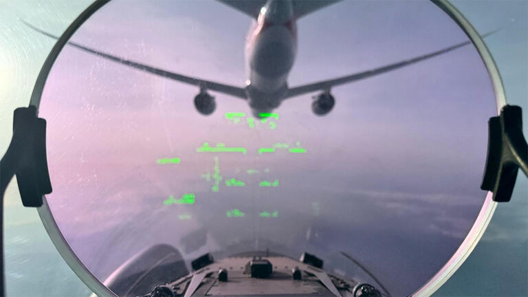 Fighter jet following an airplane