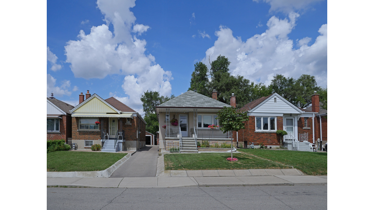 Street with row of modest 1950s style working class bungalows