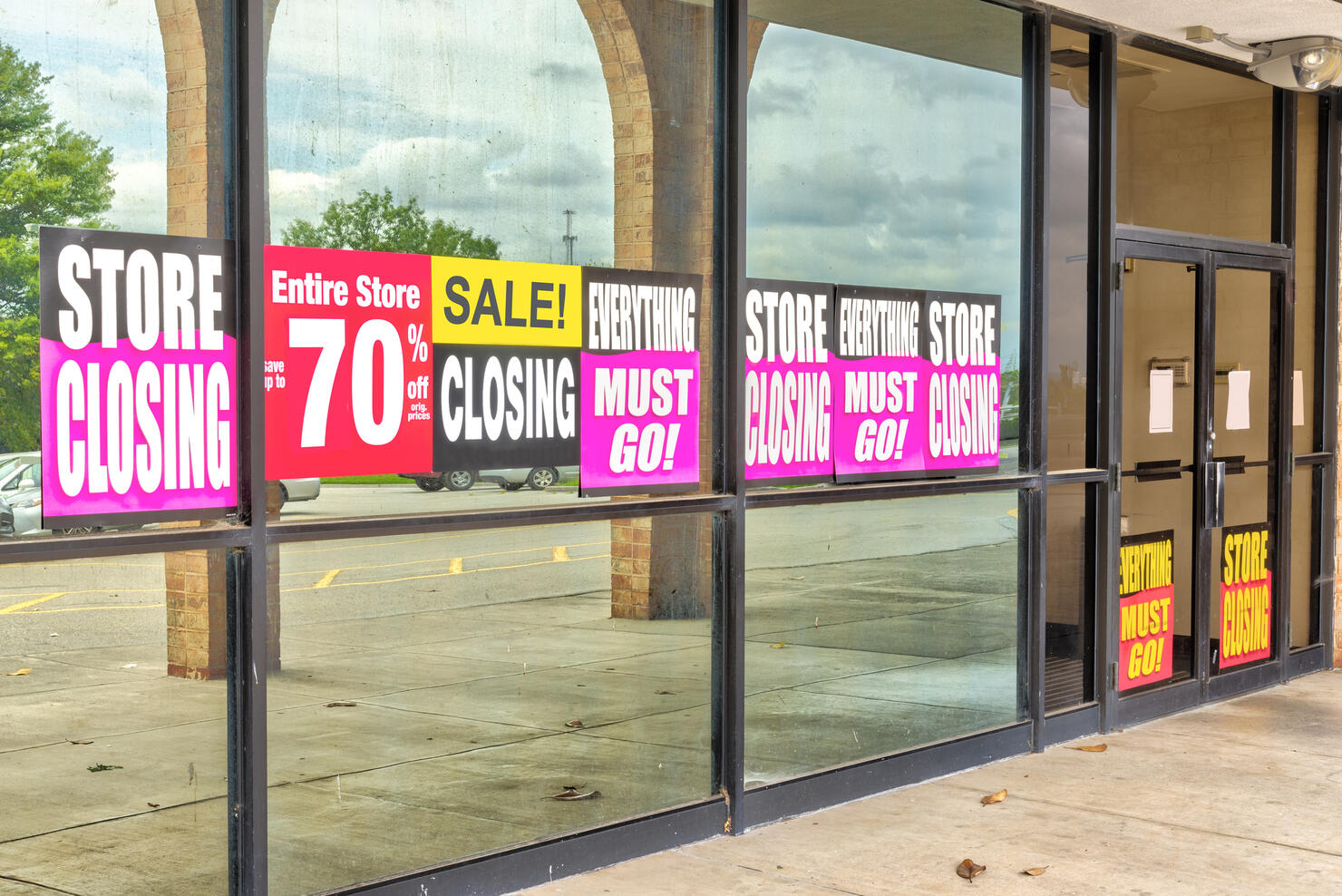 Going Out of Business Signs in Retail Store Windows