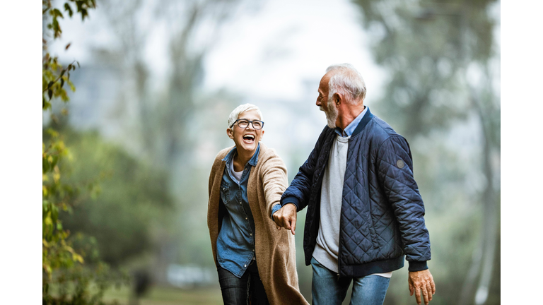 Playful senior couple having fun in the park.