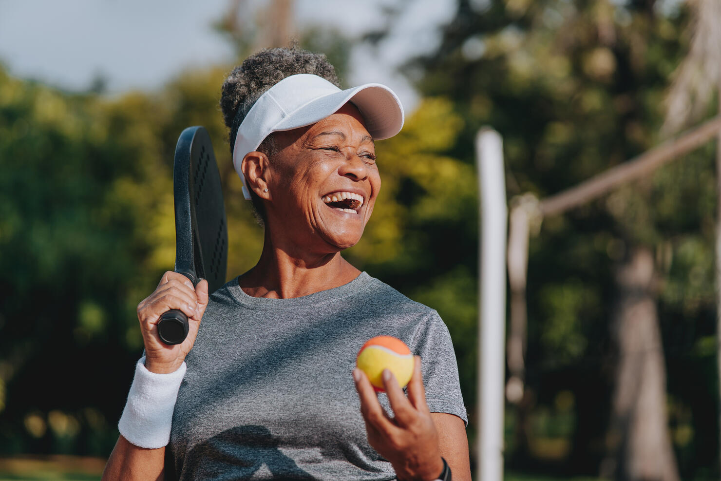 Portrait senior woman beach tennis