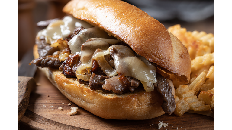 Philly cheesesteak sandwich and french fries