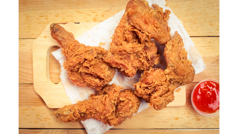 some crispy fried chicken with sauce on a wooden table