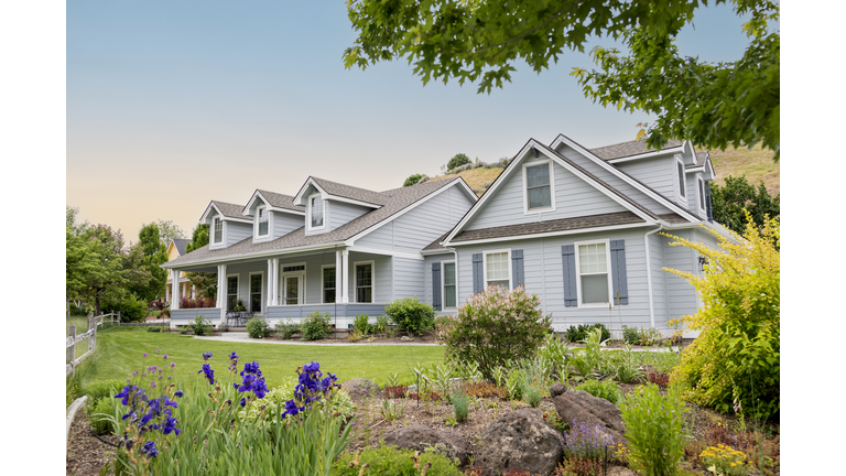 Suburban home at sunset with lawn and garden visible