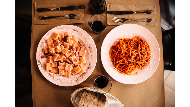 Italian pasta served for dinner with red wine in a restaurant, Rome, Italy