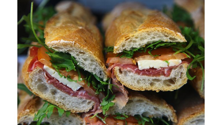 Sandwiches of Porchetta and Brie cheese with Salad rocket or Rucola and tomato