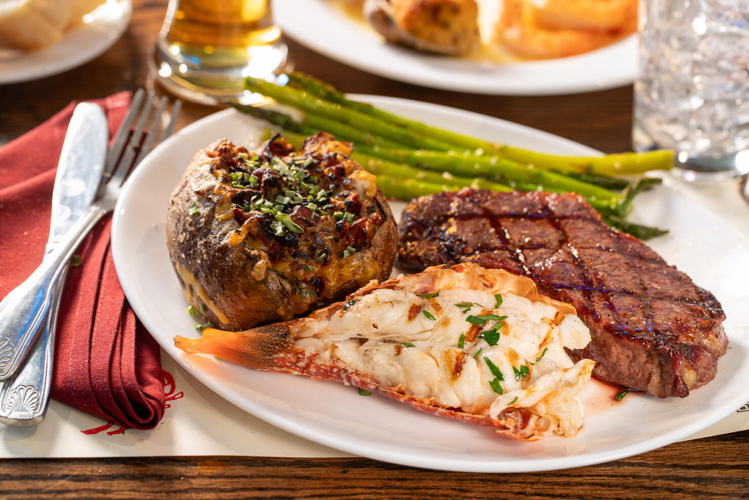Rib Eye Steak, lobster tail and stuffed baked potato dinner