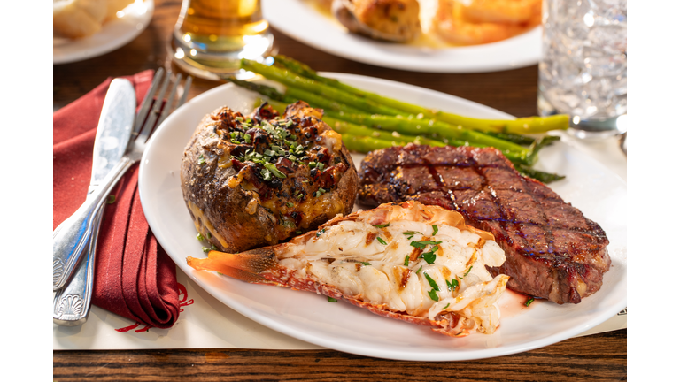 Rib Eye Steak, lobster tail and stuffed baked potato dinner
