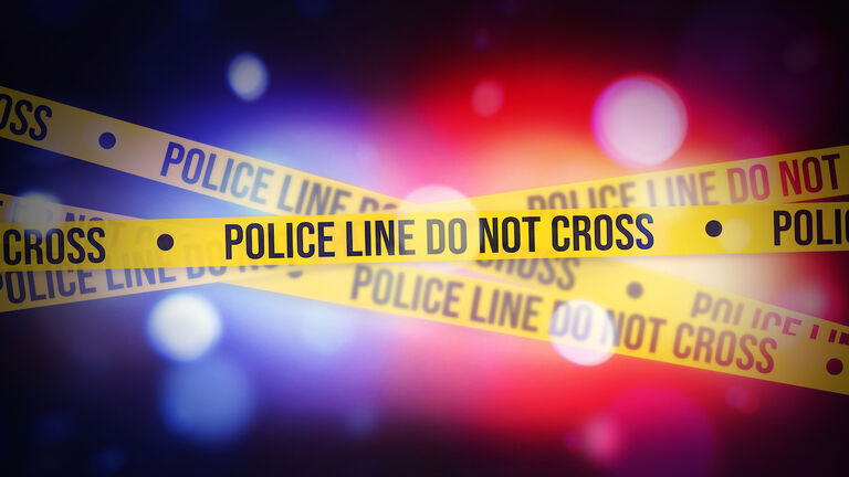 Glowing bokeh Police lights blur with Yellow tape showing typography do not cross, alert concept background. Police, legal, inquiry, warning concept