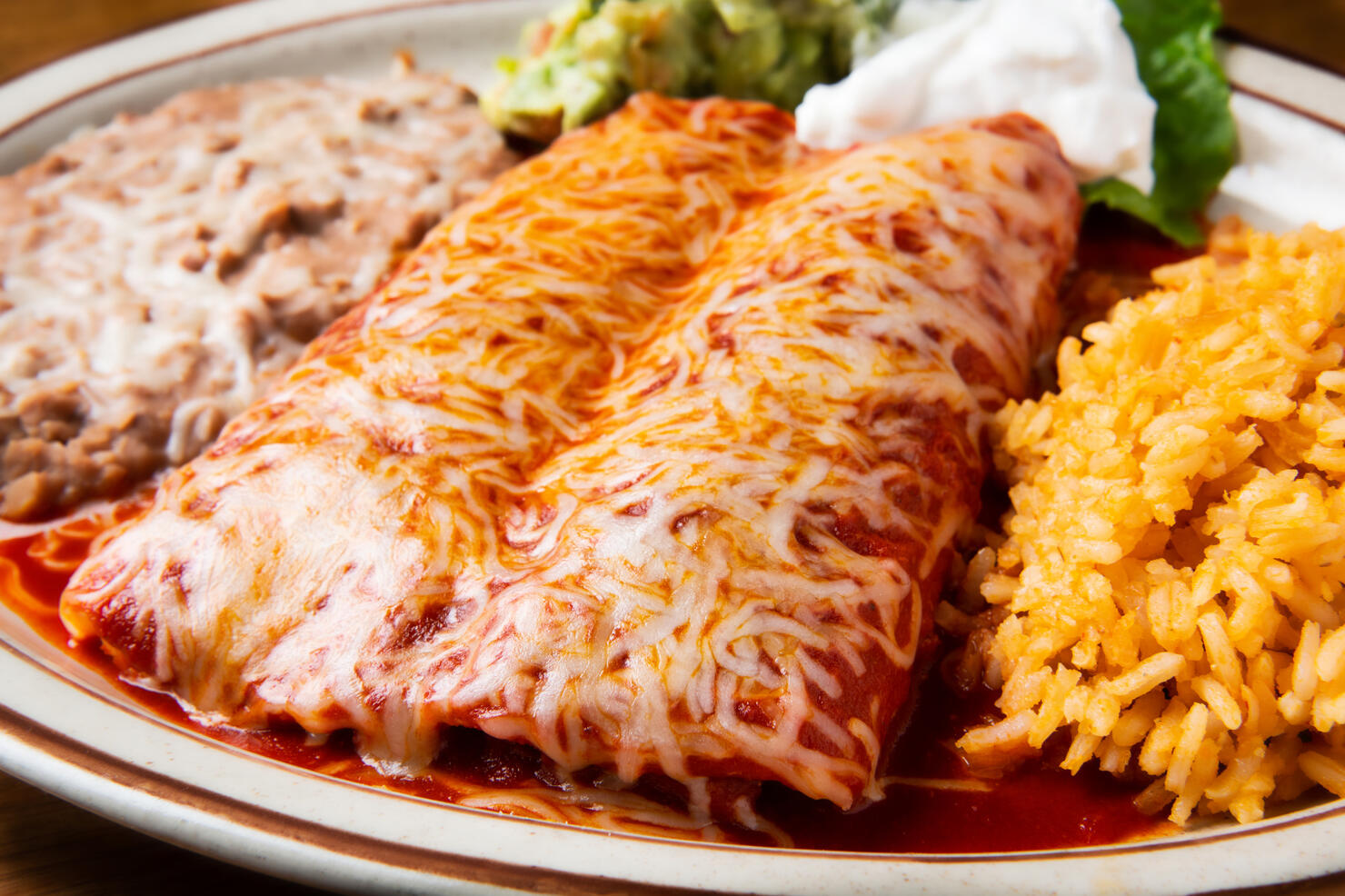Enchiladas Rojas (Two chicken enchiladas topped with red sauce)