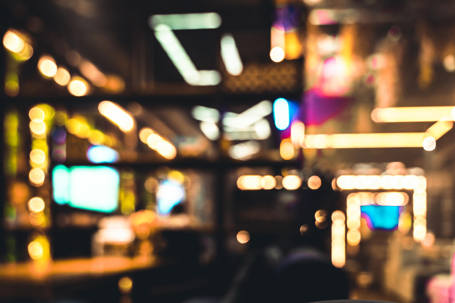 Abstract defocused background of restaurant or casino neon lights indoors