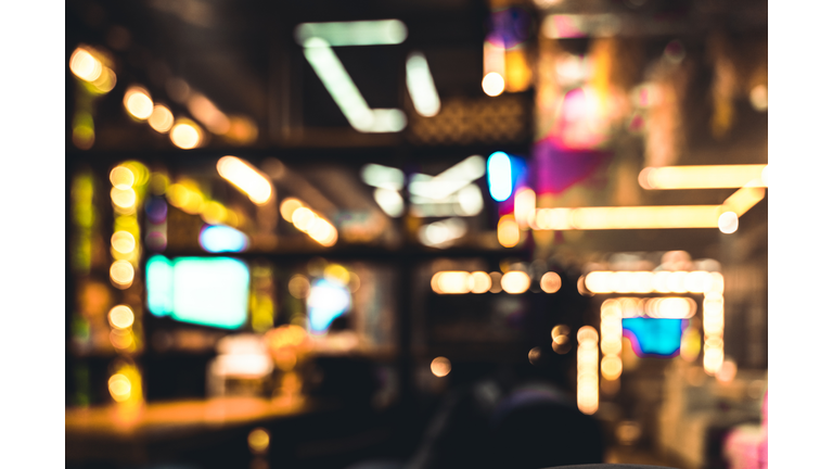 Abstract defocused background of restaurant or casino neon lights indoors
