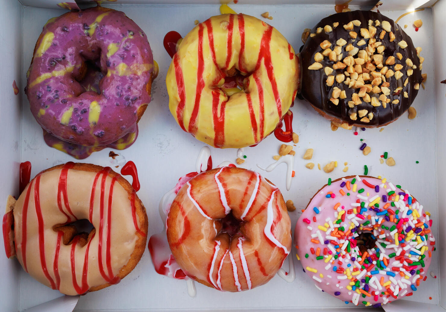 Various colourful icings and decorations on donuts