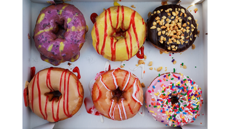 Various colourful icings and decorations on donuts