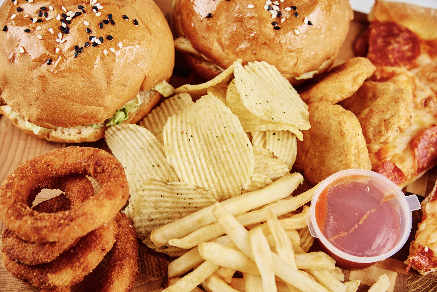 Unhealthy and junk food. Different types of fast food on the table, closeup