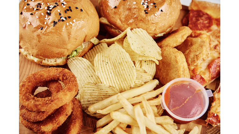 Unhealthy and junk food. Different types of fast food on the table, closeup