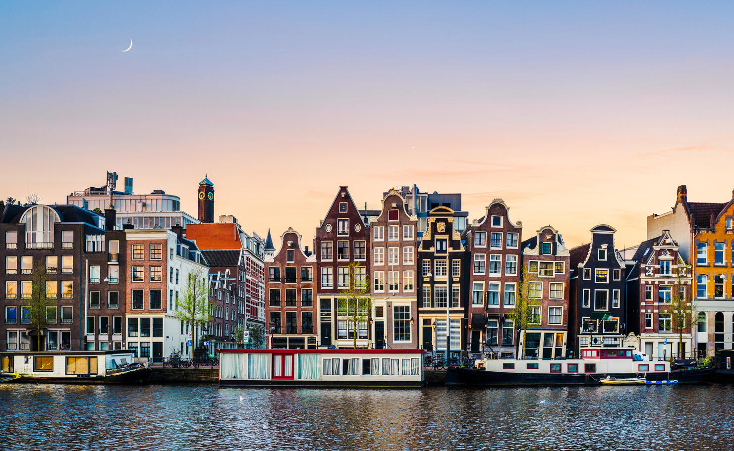 A surface level sunrise view of Amsterdam at dawn
