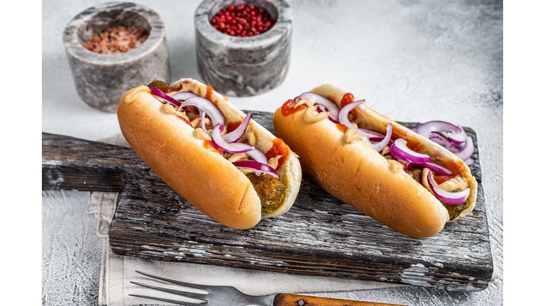 Vegetarian hot dog with with toppings and meatless sausage. White background. Top view