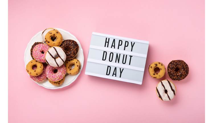 Donuts Doughnuts with Chocolate and Sprinkles on Pink Background