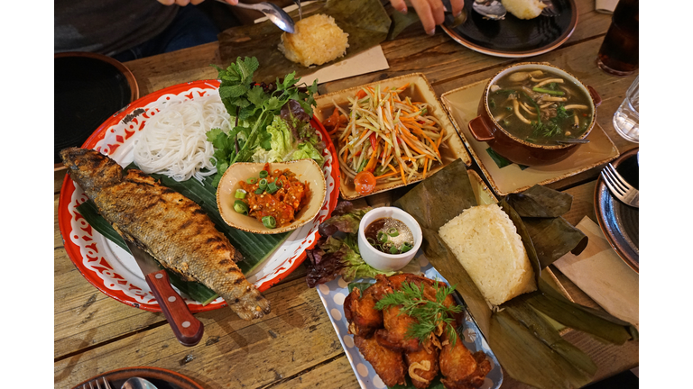 Fried chicken wings served with Thai papaya salad, Spicy tendon soup and grilled Fish