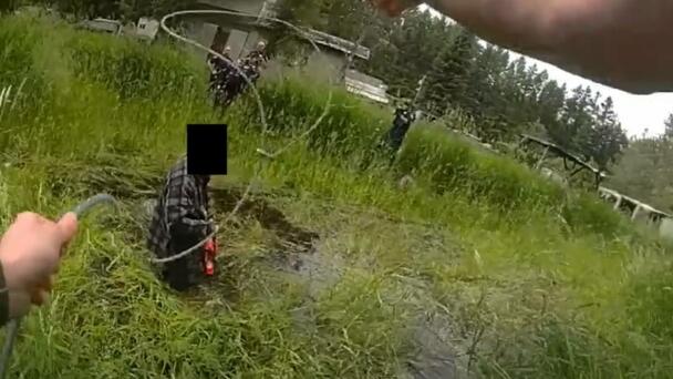Video Shows Deputy Using Lasso To Pull Chainsaw-Wielding Man Out Of Pond