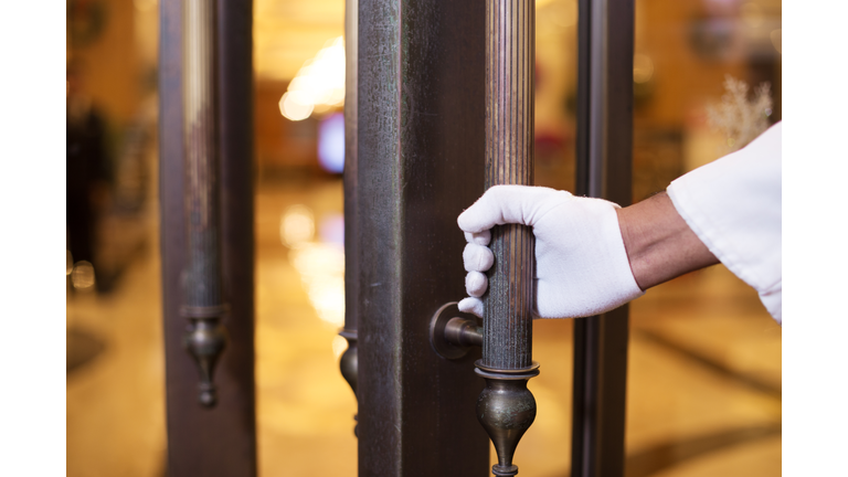 young asian porter with door