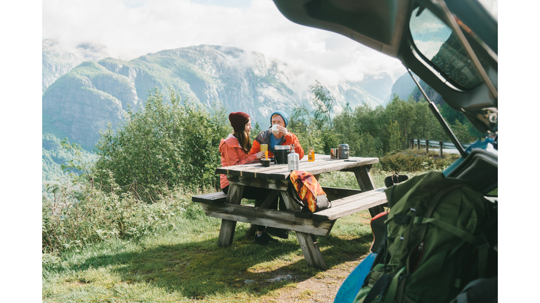 Couple have breakfast in mountains in Norway