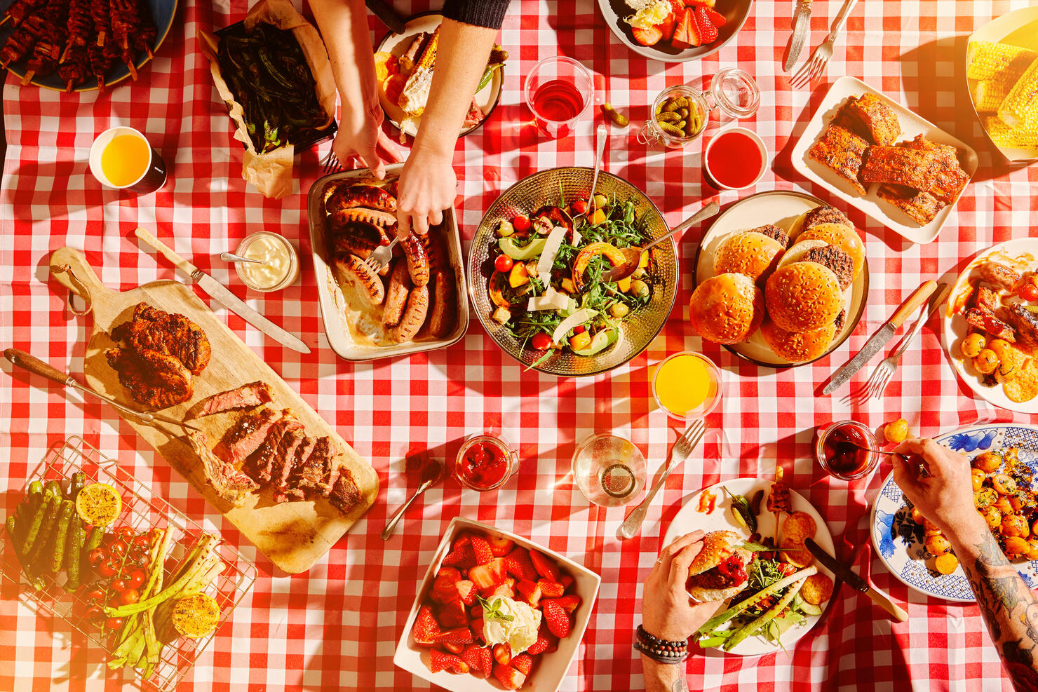 Top view of fast food, hands and people at picnic, lunch meal or snack with barbecue, casual cuisine for nutrition and health. Diner, cooking and culinary experience with buffet or summer restaurant