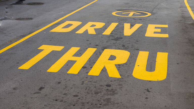 Drive thru sign painted on tarmac of local business