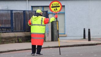 Crossing Guard Banned from High-Fiving Kids After Drivers Complain About Delay