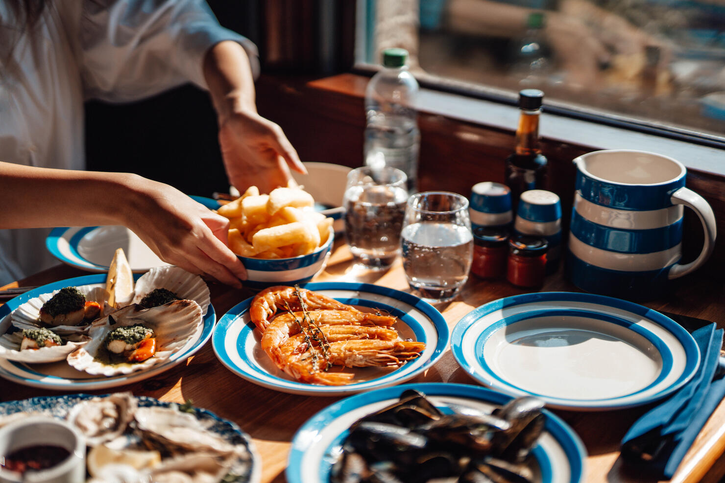 Friends Eating Fresh Seafood In Restaurant