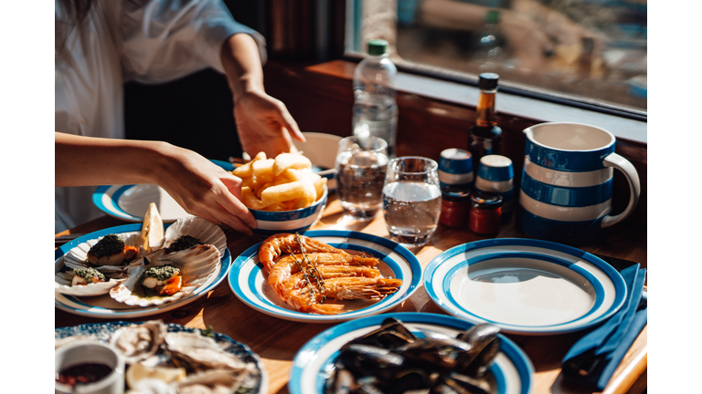 Friends Eating Fresh Seafood In Restaurant